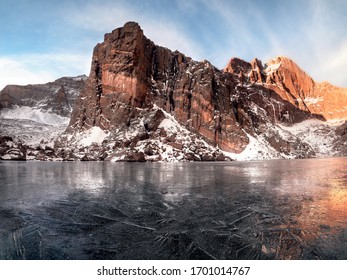 Sunrise at a frozen Chasm Lake in Rocky Mountain National Park in Colorado. 