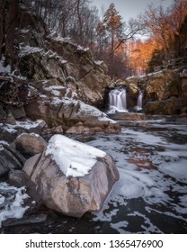 Sunrise Glow Hitting The Trees Behind The Waterfall At Scott's Run Nature Preserve In Northern Virginia With A Light Dusting Of Snow.