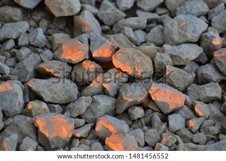 Sunrise Golden Hour light painting rocks with natural light pink orange and red glow on surfaces facing the rising sun 