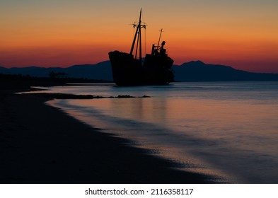 Sunrise At Gytheio, Peloponnese, Greece With The Dimitrios Shipwreck Silhouette In The Foreground.