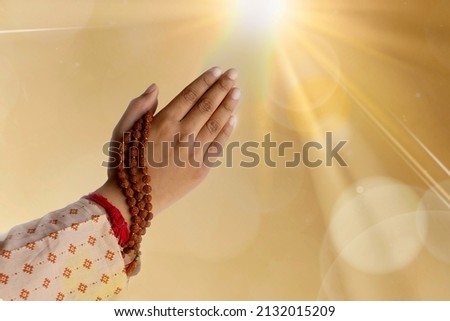 Sunrise and hands joined together for prayer