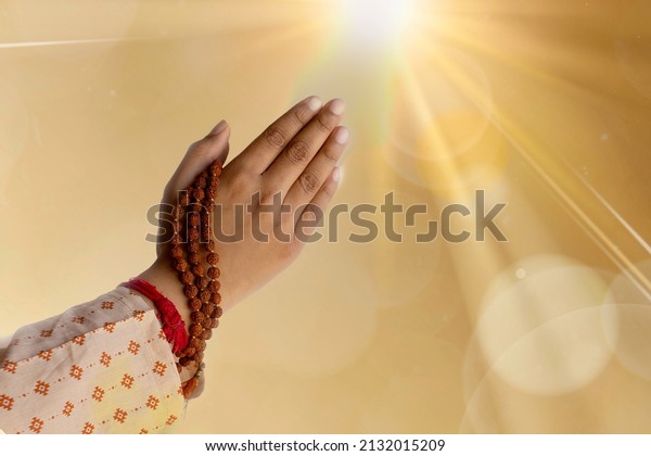 Sunrise and hands\
joined together for\
prayer