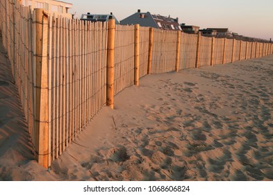 The Sunrise Illuminates A Fence For Beach Erosion Control At Bethany Beach, Delaware