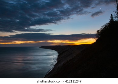 Sunrise At Lake Superior. The Moon Still Hangs Overhead. Grand Sable Dunes Sits Amid Pictured Rocks National Lakeshore In The Upper Peninsula Of Michigan