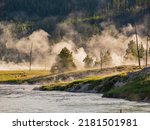 Sunrise landsacpe along the Firehole River with steam and forest at Wyoming