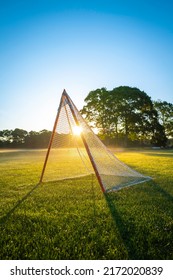 Sunrise Landscape Over The Empty Green Field With Lacrosse Net