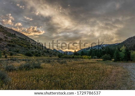 Sunrise light hits the clouds at a rural ranch in Idaho. 