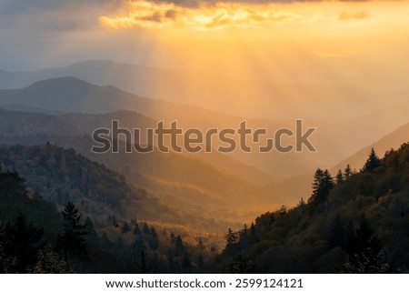 Sunrise light rays over the rolling mountain ridges in autumn. Smoky Mountains National Park, Tennessee