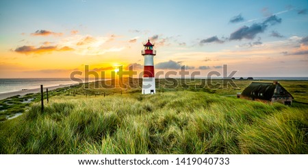 Sunrise at lighthouse in List on the island of Sylt, Schleswig-Holstein, Germany