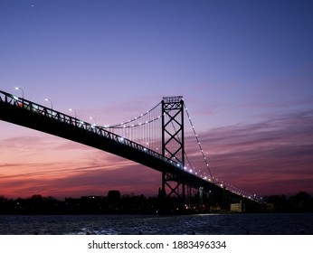 Sunrise Looking At The Ambassador (suspension) Bridge And Windsor, Ontario, Canada, From Riverside Park In Detroit, Michigan. 