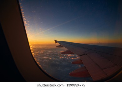 Sunrise In Morning With Airplane Wing, Clouds And Sky As See Through Window Of Airplane