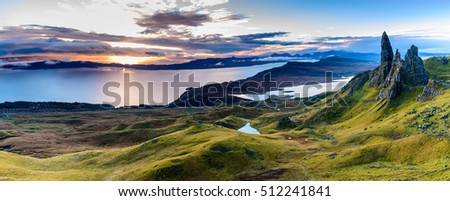 Sunrise at The Old Man of Storr - beautiful panorama of an amazing scenery with vivid colors - symbolic tourist attraction - mystery around the landmark - spectacular panorama with first rays of light