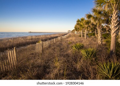 Sunrise On The Atlantic Coast In Downtown Myrtle Beach, South Carolina, USA With Ocean Fishing Pier At The Horizon.