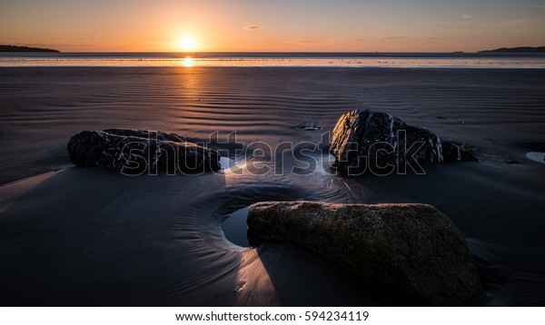 Sunrise on\
the beach at Bull Island, Dublin,\
Ireland