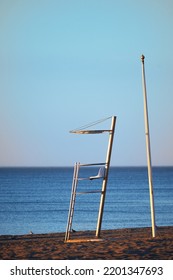 Sunrise On The Beach With A Detail Of A Lifeguard Tower And The Blue Sea In The Background.