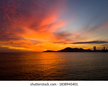 sunrise on the beach 
sea ​​beach sun coastline sand morning landscape silhouette dark yellow clouds mountains tourism travel - Powered by Shutterstock