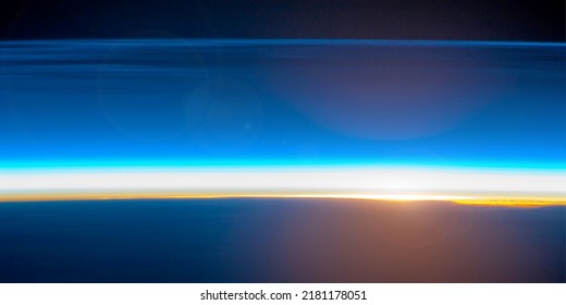 Sunrise On The Earth's Horizon, Polar Mesospheric Clouds Illuminated By Orbital Sunrise. World Horizon At Sunrise. Elements Of This Image Furnished By NASA. Selective Focus.