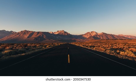 sunrise on an empty highway in the Eastern Sierra Mountains near Mammoth mountain, CA, USA - Powered by Shutterstock