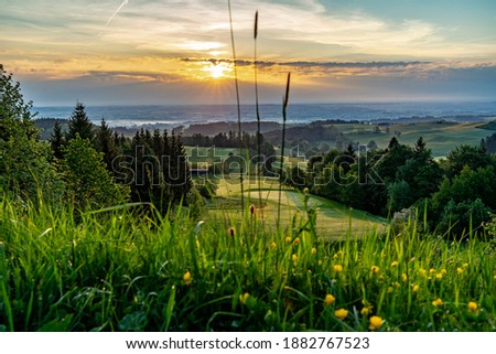 Sunrise on a golfcourse in the alps