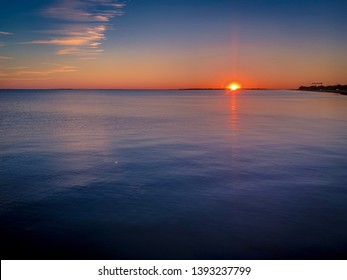 Sunrise On The Gulf Coast Of Mississippi With Very Still, Almost Glass Like Water