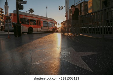 Sunrise on Hollywood Boulevard Walk of Fame as a city Bus drives by