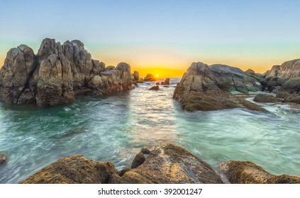 Sunrise On Reef Coast With The Path Of The Stone Blocking The Way To Sunrise Skyline Star, Below The Water Surface Smooth Waves Blue Sea Make This Place More Beautiful And Romantic