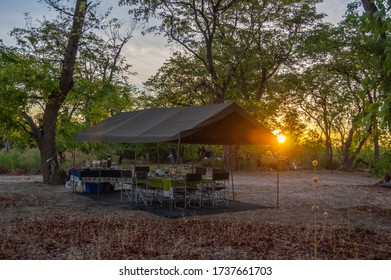 Sunrise On A Safari Camp In The Botswana Wilderness