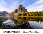 Sunrise on Sunburst Lake with Mount Assiniboine in autumn forest at provincial park, Canada