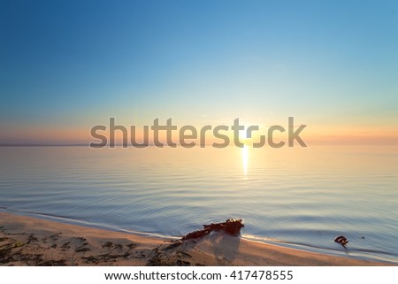sunrise on the water / Early summer morning bright sky Beach