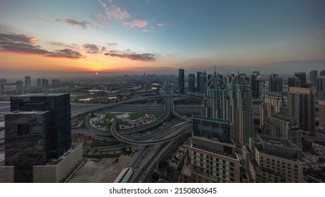 Sunrise over Dubai marina and JLT skyscrapers along Sheikh Zayed Road aerial morning timelapse. Residential and office buildings from above. Orange sky above golf course
