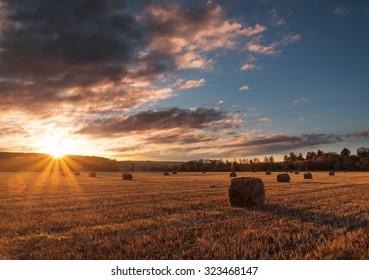 Sunrise Over A Field With Many Hay Bales. Autumn, Russia.