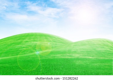 Sunrise Over Green Grass Hills With Blue Sky