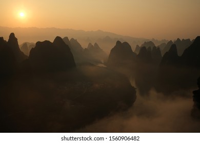 , Sunrise over Li river ,strangely shaped and beautiful limestone hills and mountain formations called karsts. Taken from the famous Chinese tourist photospot Yangshuo Xianggong Mountain
