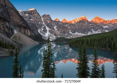Sunrise over Moraine Lake with the reflection of the mountains, Banff National Park, Canadian Rockies, Alberta, Canada.