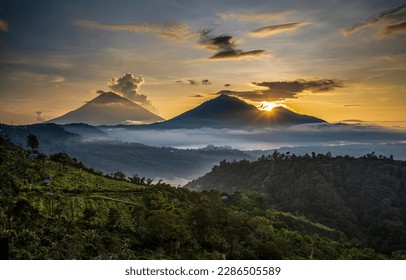 Sunrise over a mountain peak in the early foggy morning. Mountain sunrise landscape. Sunrise in mountains. Beautiful mountain sunrise landscape
