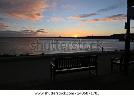 Sunrise over mouth of River Tyne in North East England on winter morning, viewed from North Shields quay