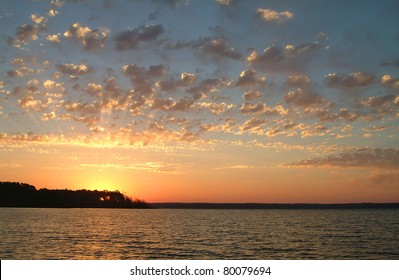 Sunrise Over Quiet Lake.  The Sun Rises Over Calm Water At Lake Fork In Texas, A Favorite Lake For Bass Fishing.