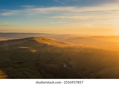 Sunrise over the rolling hills of Wales revealing vast landscapes and golden light illuminating the morning sky - Powered by Shutterstock