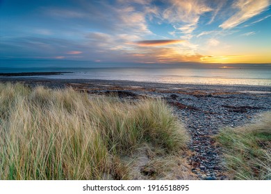 Sunrise over the sand dunes at New England Bay near Stranraer on the west coast of Scotland
