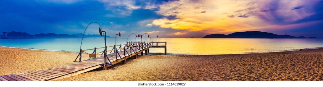 Sunrise over the sea. Pier on the foreground. Amazing landscape. Panorama