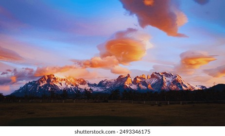 Sunrise over snow-capped mountains with a golden glow. The sky is vibrant with orange and blue hues. Perfect for nature lovers and travelers. - Powered by Shutterstock