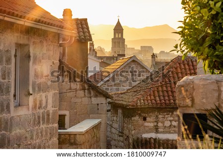 Sunrise over the Split old town. Narrow medieval paved street in old town of Split at sunrise, Croatia
