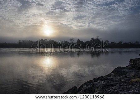 Sunrise over the Tambopata River in the Amazonas Region near Puerto Maldonado, Peru