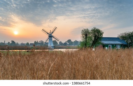 Sunrise Over Thurne Windmill From The Banks Of The River On The Norfolk Broads