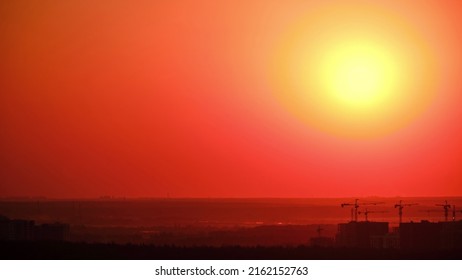 Sunrise Over Tower Cranes With New Houses Under Construction, Timelapse. The Big Yellow Sun Rises In The Morning Sky In The Mist, Time Lapse