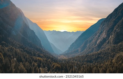 Sunrise Over the Valley: The first light of dawn spills over the horizon, casting a golden hue across the lush valley. The morning sky is painted with soft pastels of pink and orange, while the mist g
