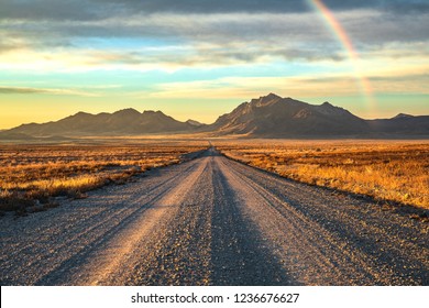 Sunrise And Rainbow Over Dirt Gravel Road In Utah Desert Mormon Pioneer Trail