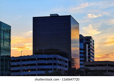 Sunrise reflected in glass office buildings