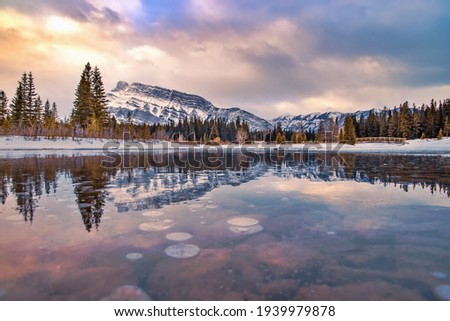 Sunrise reflecting into a frozen Cascade Ponds