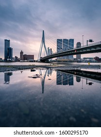 Sunrise at Rotterdam, the Netherlands, relection of the skyline in a puddle after the rain